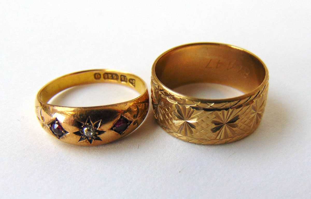 An early 20th century 15ct gold, diamond and ruby gypsy ring together with a 9ct gold engraved band.