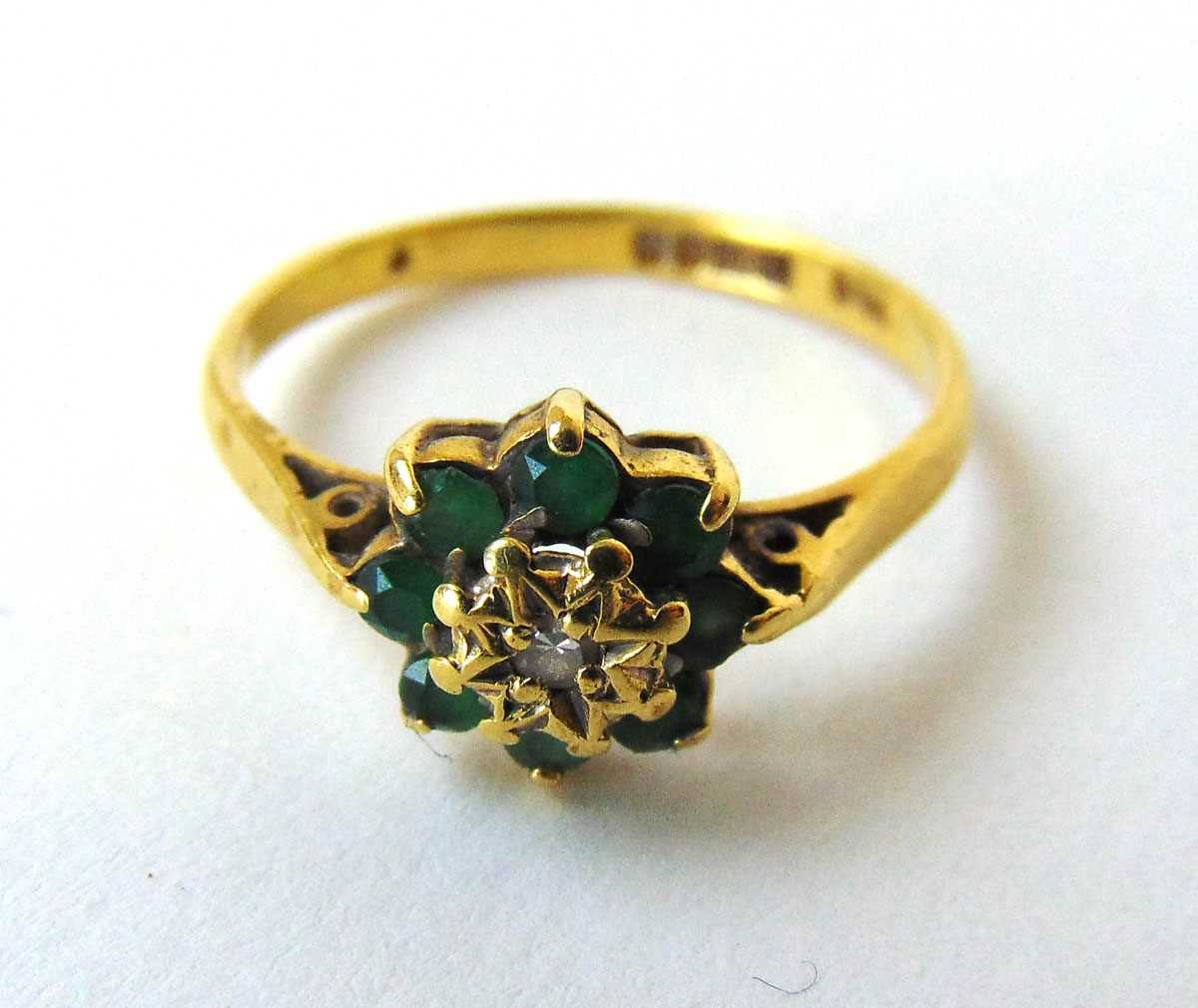 An 18ct gold, diamond and emerald cluster ring. Size N 1/2. Approx. weight 2.4g