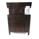 A 17th/18th century oak court cupboard, with stylised carved leaf frieze flanked by turned pendants,
