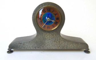 An Arts and Crafts 'Tudric' pewter mantel clock, retailed by Liberty & Co., circa 1900, the circular