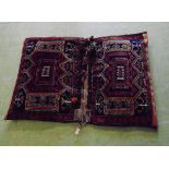 An early 20th century Khorjin saddle bag with red and blue ground decoration. 120cm x 85cm