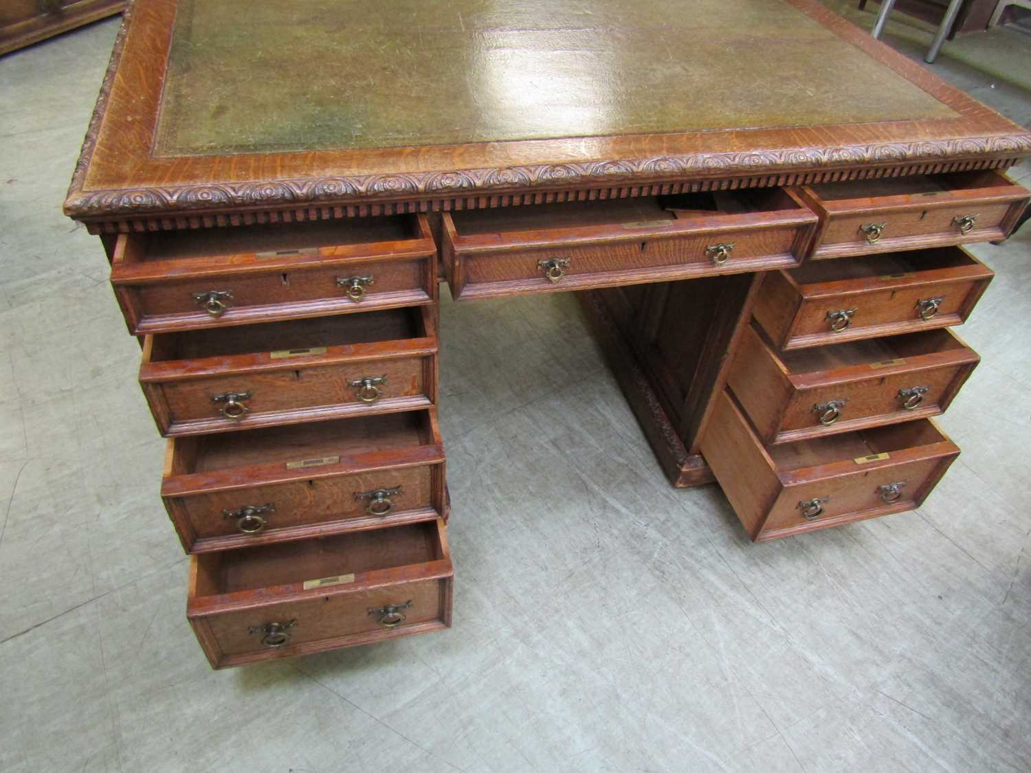 A late Victorian oak partners desk, with green tooled leather writing surface, above a series of - Image 15 of 15