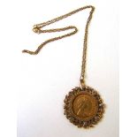 A 1982 half sovereign mounted in a 9ct gold surround with chain. Approx. weight 9g