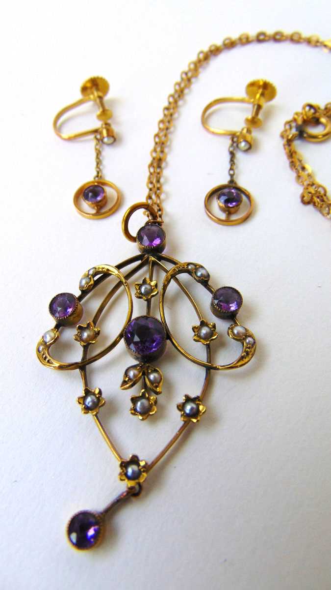 An Edwardian yellow metal, amethyst and seed pearl pendant marked '9ct'. Together with a pair of - Image 2 of 3