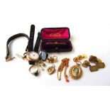 An early 20th century leather jewellery travel case with contents to include yellow metal locket,