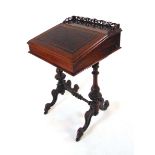 A Victorian rosewood Davenport, with fretwork gallery above a tooled red leather writing surface,