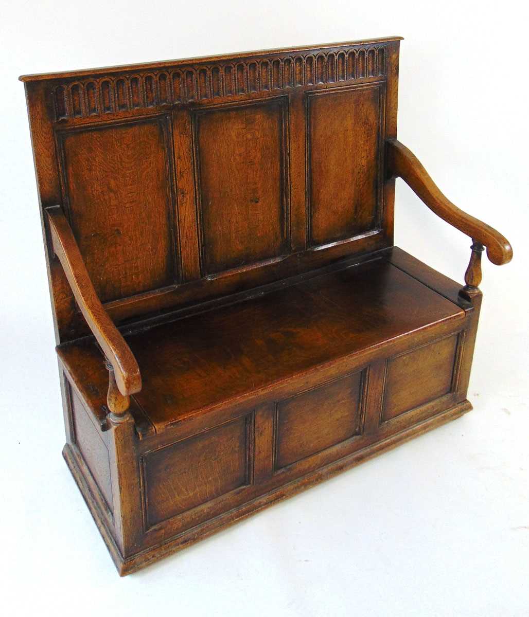 An early 20th century reproduction oak box settle, with a narrow arcaded frieze above three - Image 6 of 7