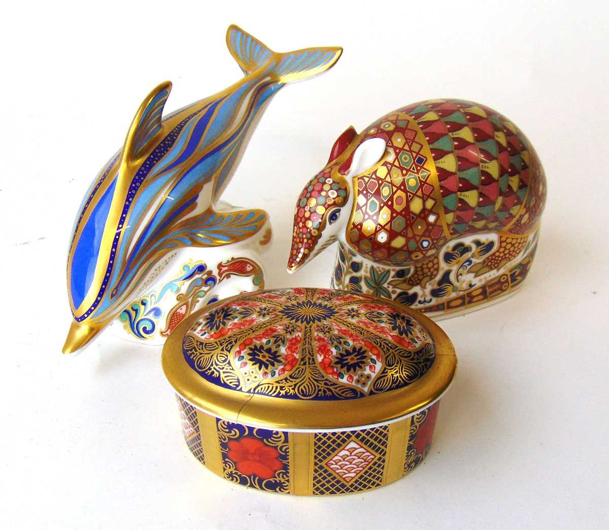 Two Royal Crown Derby Imari paperweights, modelled as an Armadillo and a Dolphin, each with gold