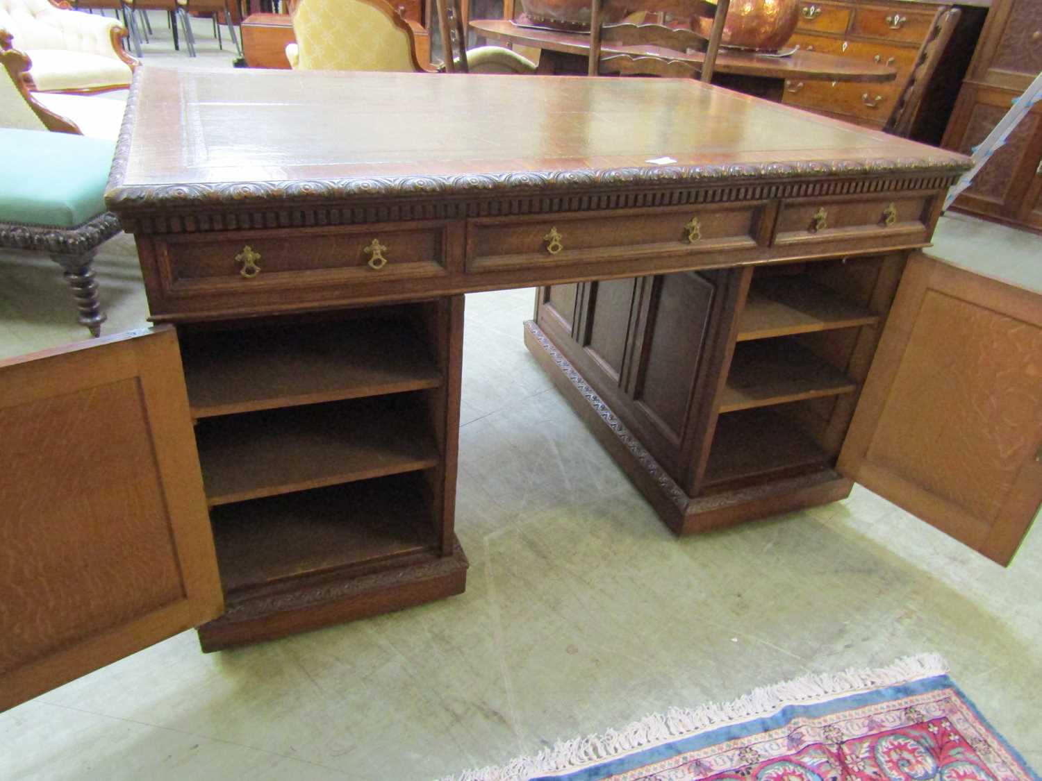 A late Victorian oak partners desk, with green tooled leather writing surface, above a series of - Image 7 of 15