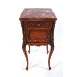 An early 20th century French oak and chestnut pot cupboard, with inset rouge marble top, above a