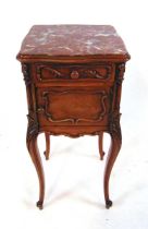 An early 20th century French oak and chestnut pot cupboard, with inset rouge marble top, above a