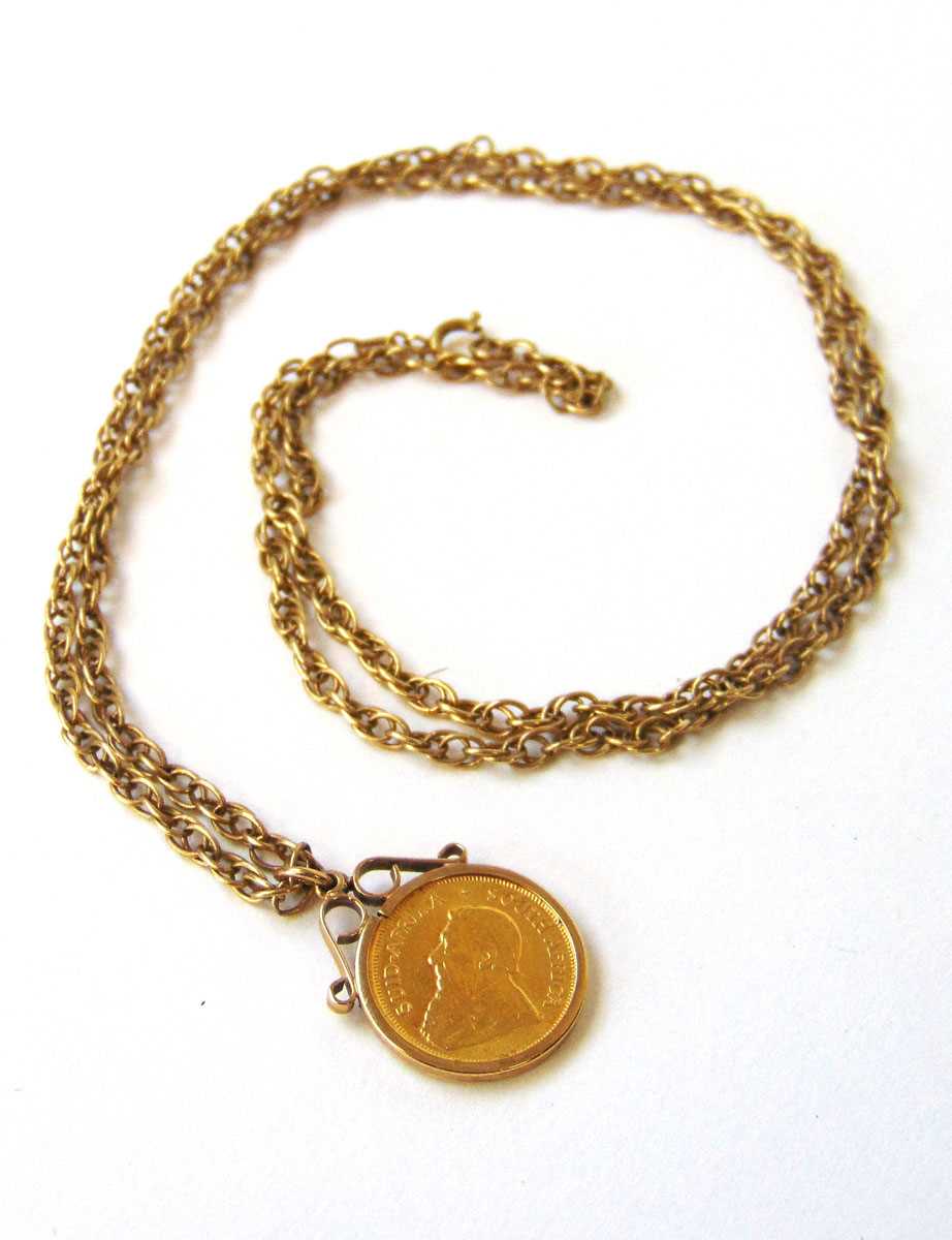 A South Africa 1980 1/10 oz Krugerrand in a 9ct gold pendant mounted suspended from a 9ct gold