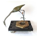 A life size lead Heron garden ornament, modelled facing downwards, on a concrete base, 88cm wide ,