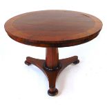 A 19th century rosewood tilt top table, with crossbanded edge and brass stringing, on an octagonal