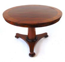 A 19th century rosewood tilt top table, with crossbanded edge and brass stringing, on an octagonal