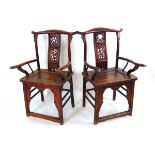 A pair of Chinese elm official hat armchairs, Qing dynasty, the shaped top rail above a pierced ruyi