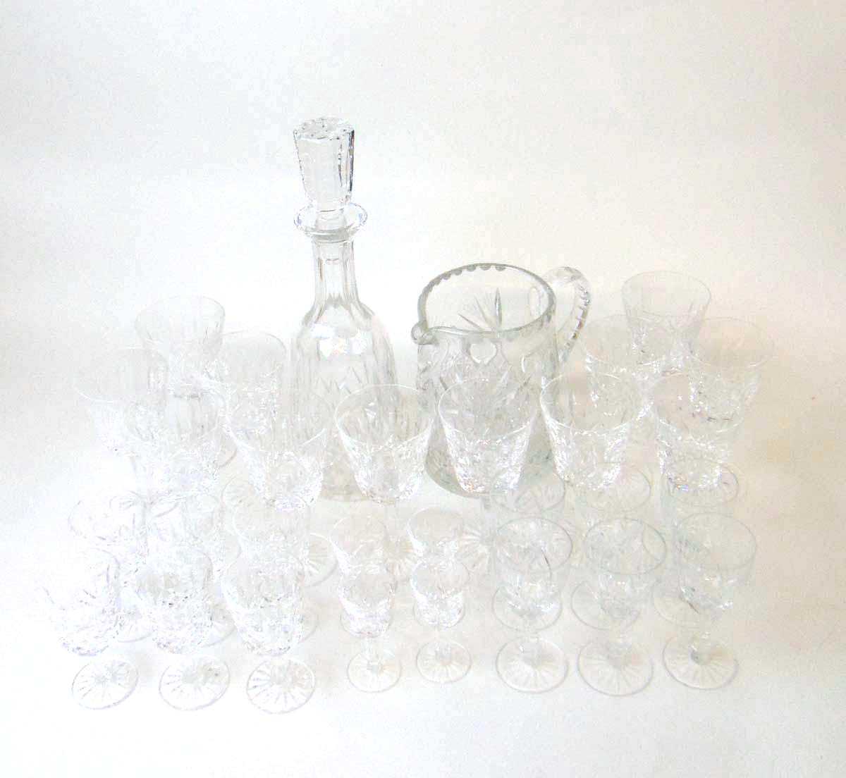 A part suite of Waterford 'Lismore' pattern drinking glasses, comprising a decanter and stopper,