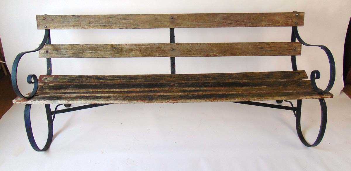 A late Victorian green painted wrought iron and wooden slatted garden bench on scrolled supports, - Image 4 of 4