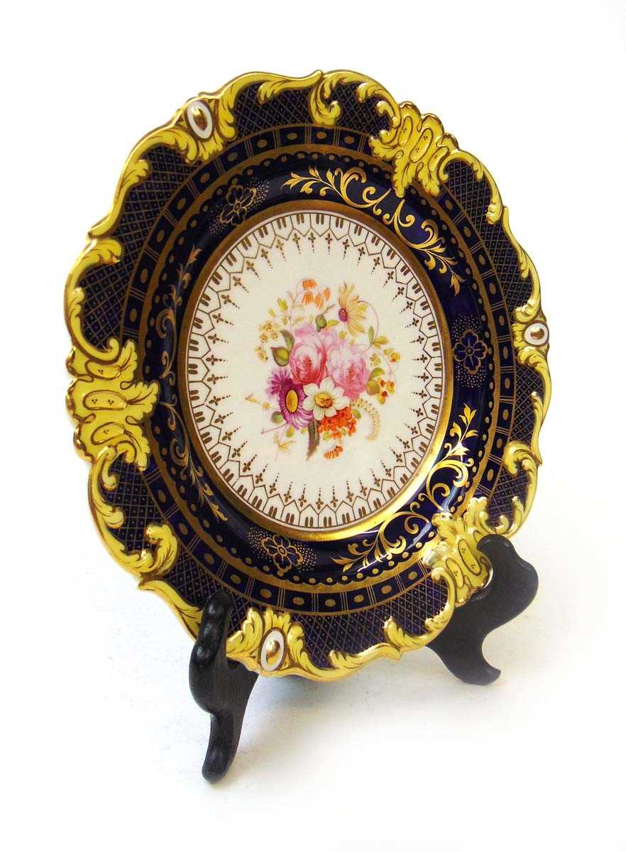 A 19th century English porcelain cabinet plate, with hand painted floral bouquet, within a royal - Image 2 of 2