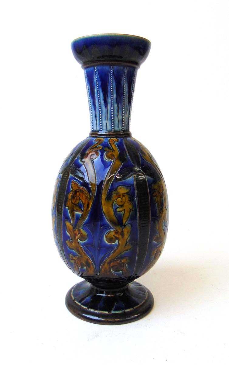 A Doulton Lambeth vase by Florence Barlow, incised with daggers and foliate scrolls against a blue