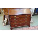 A George III mahogany bureau, the interior fitted with pigeon holes and drawers, above four oak