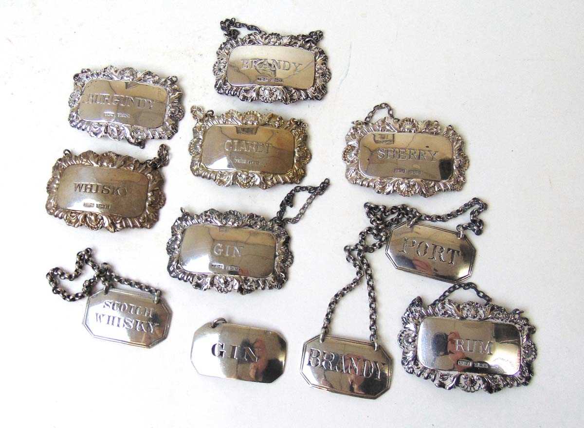 A collection of silver spirit labels, comprising a set of three for, Charles Stuart Harris, London