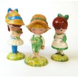 A set of three Beswick Joan Walsh Anglund character figures, modelled as two girls and a boy,