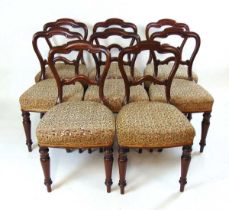 A set of eight Victorian mahogany dining chairs, with shaped top rail and stuff over horsehair