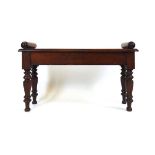 An early 19th century mahogany window seat, the top with moulded edge and turned bolsters, on turned