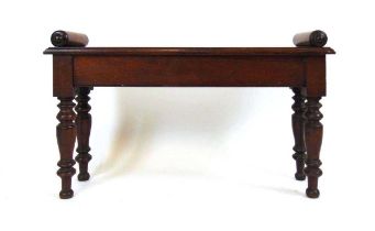 An early 19th century mahogany window seat, the top with moulded edge and turned bolsters, on turned