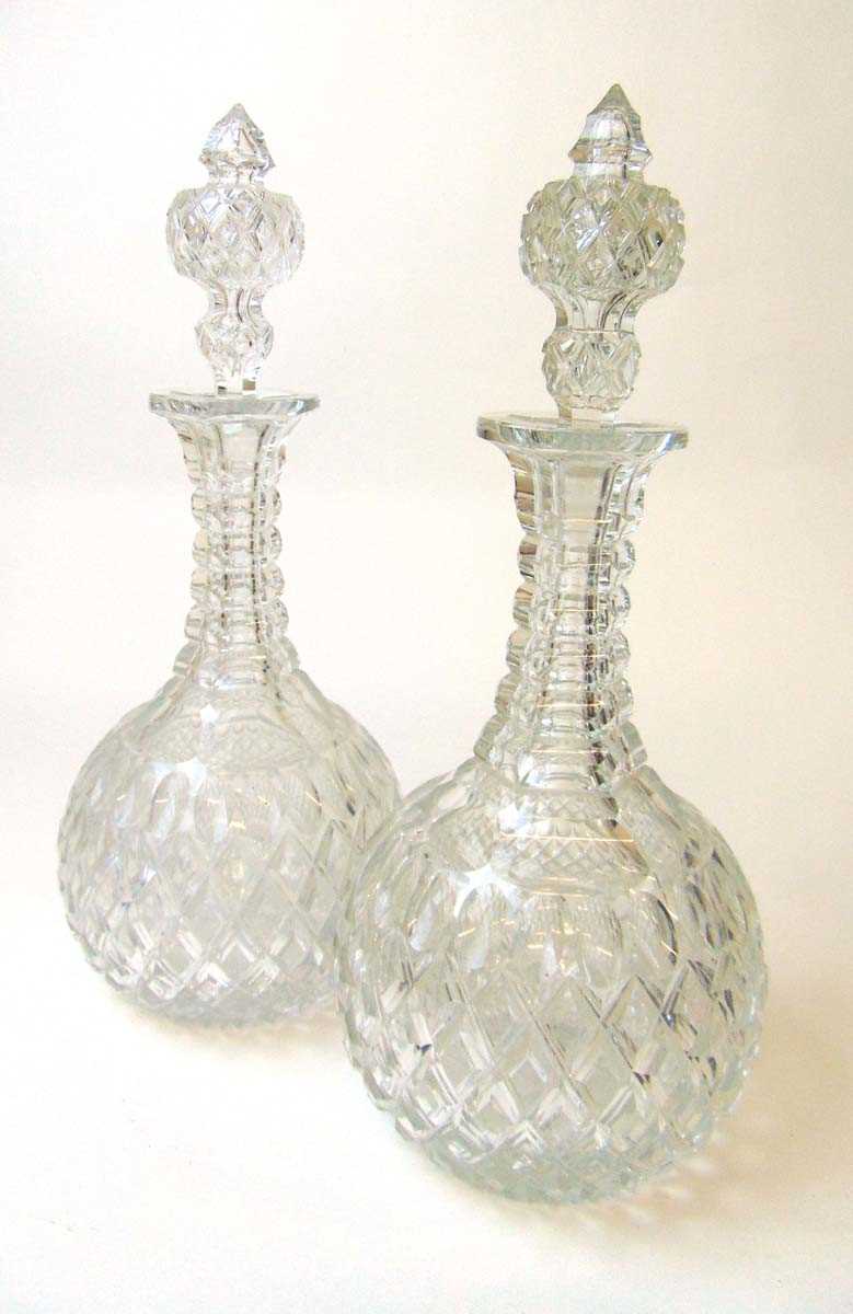 A good pair of early 20th century cut glass decanters, with hollow hob nail decorated stoppers,