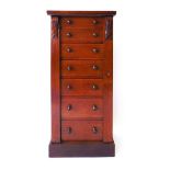 A Victorian mahogany Wellington chest, the seven drawers with turned knops, flanked by carved