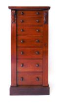 A Victorian mahogany Wellington chest, the seven drawers with turned knops, flanked by carved