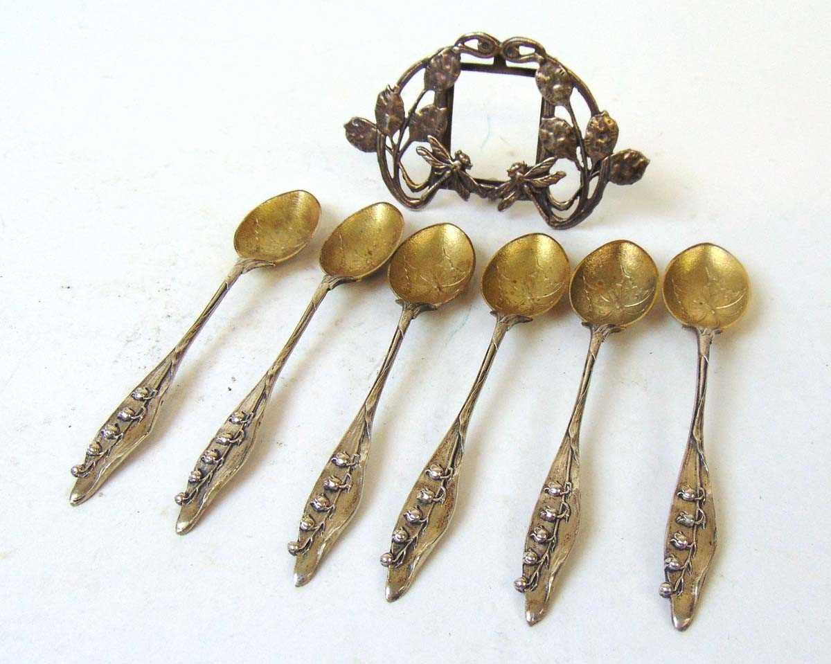 A set of six German silver teaspoons, the gilt bowls decorated with a butterfly, the terminals