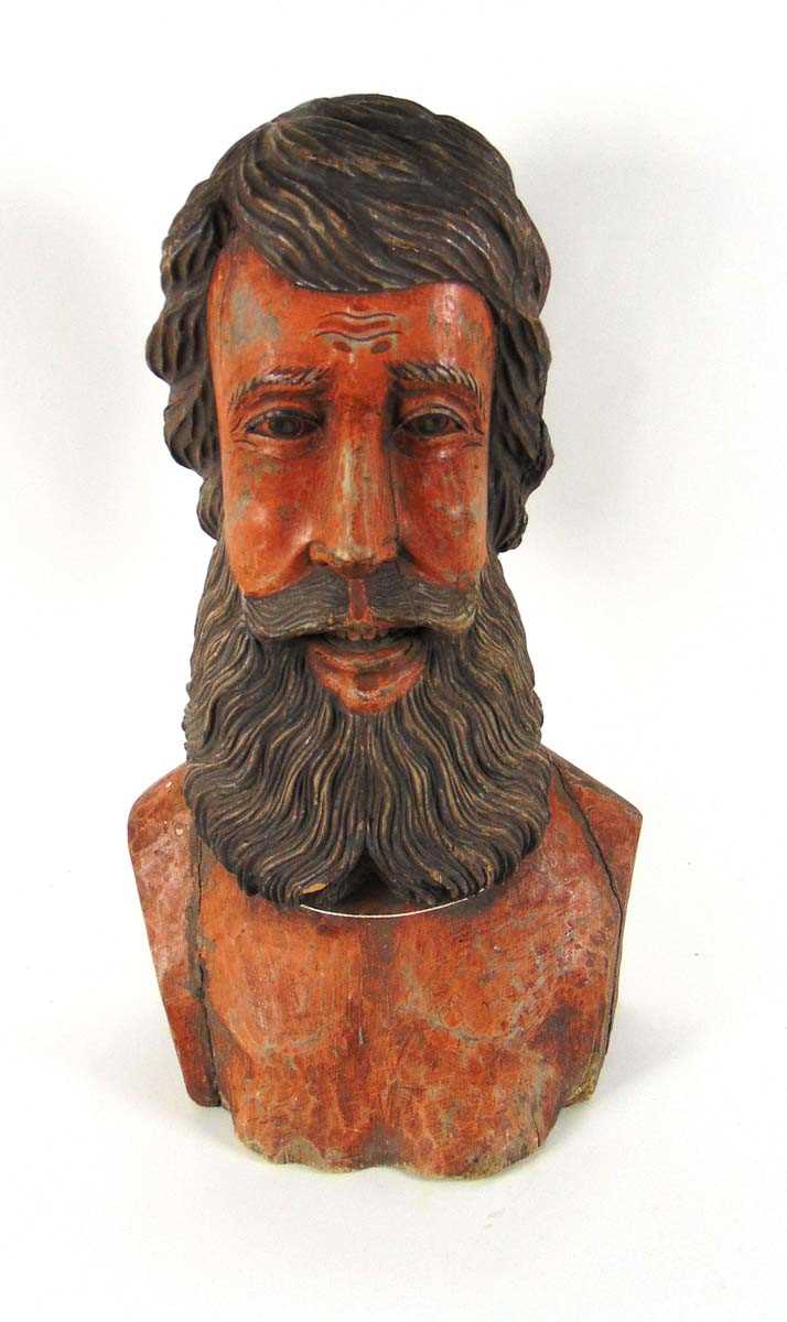 A large carved wood bust of a bearded man, painted in flesh tones with a faded dark brown beard