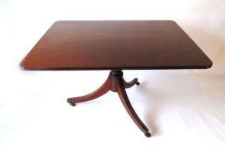 A Regency mahogany tilt top breakfast table, the rectangular top with rounded corners and lip