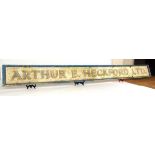 A large painted wood shop sign advertising 'Arthur E Heckford Ltd', 350cm x 35.5cm Graces Guide