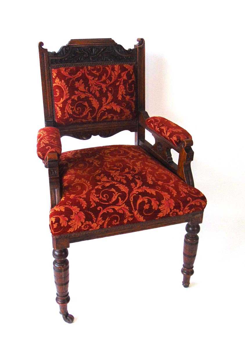 A Victorian upholstered armchair with carved oak show frame, the top rail with carved foliate - Image 2 of 2