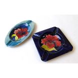 Two William Moorcroft Hibiscus pattern ashtrays, early to mid 20th century, each with applied