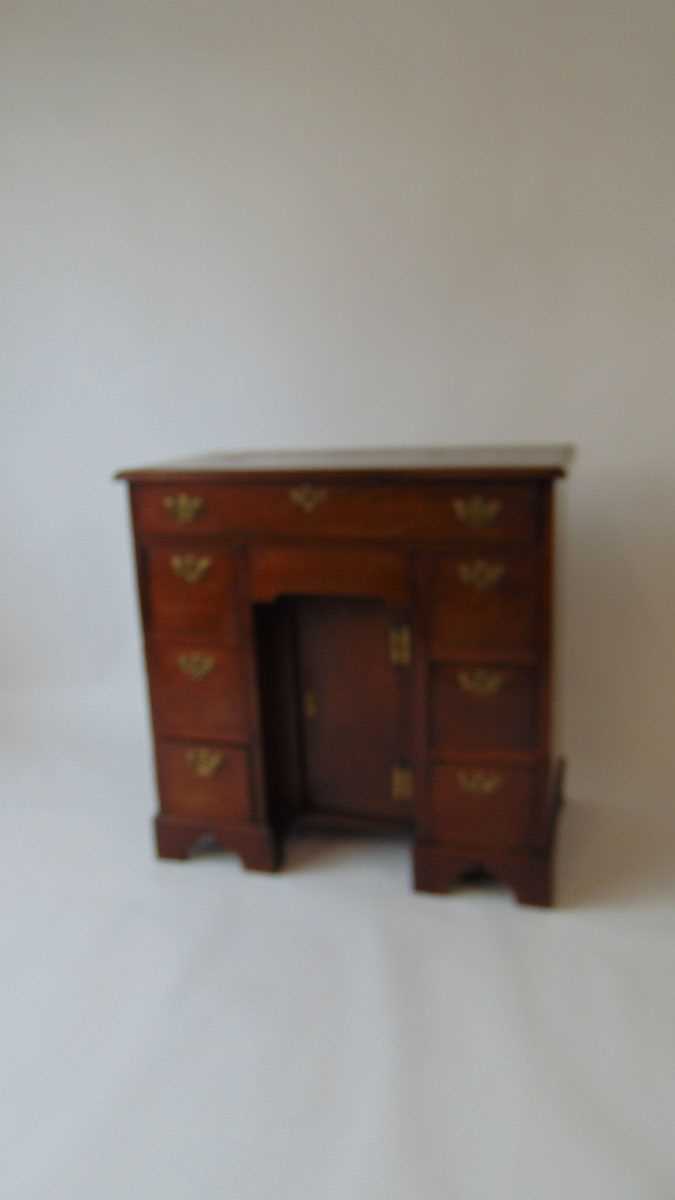 An 18th century mahogany kneehole desk, with applied moulded edge, over an arrangement of one long - Image 2 of 4