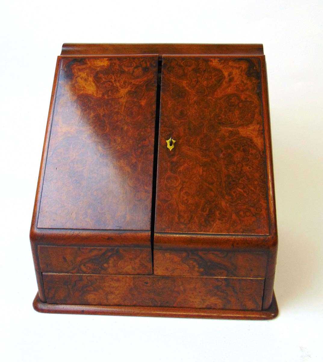 A Victorian walnut stationery cabinet, with two well figured sloping doors opening to reveal a