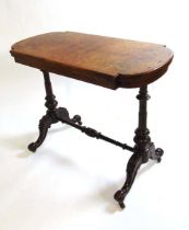 A Victorian inlaid walnut turn over top card table, the quarter veneered book matched top on