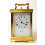 A good brass cased carriage clock, with repeater action, the dial inscribed for Woodford, Est