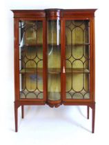 An Edwardian mahogany display case, with satinwood crossbanding and stringing, with bow front glazed