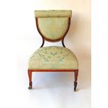 A late Victorian classical revival nursing chair, the rosewood frame with inlaid stringing, the seat