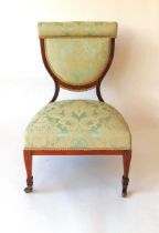 A late Victorian classical revival nursing chair, the rosewood frame with inlaid stringing, the seat
