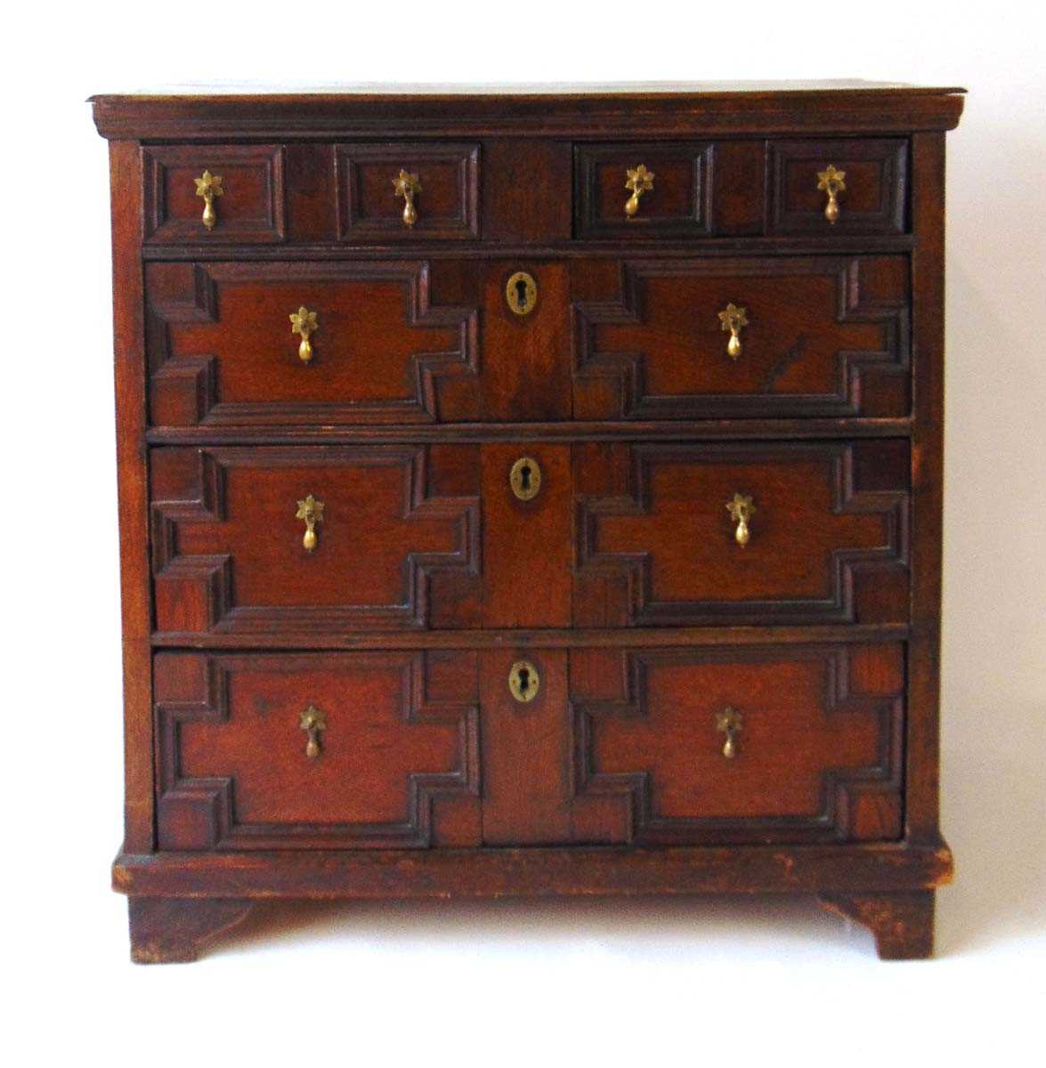 A 19th century oak chest of drawers, with an arrangement of two short over three long graduated