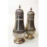 A pair of large silver dredgers, Atkin brothers, Sheffield 1913, with part gadrooned body on a