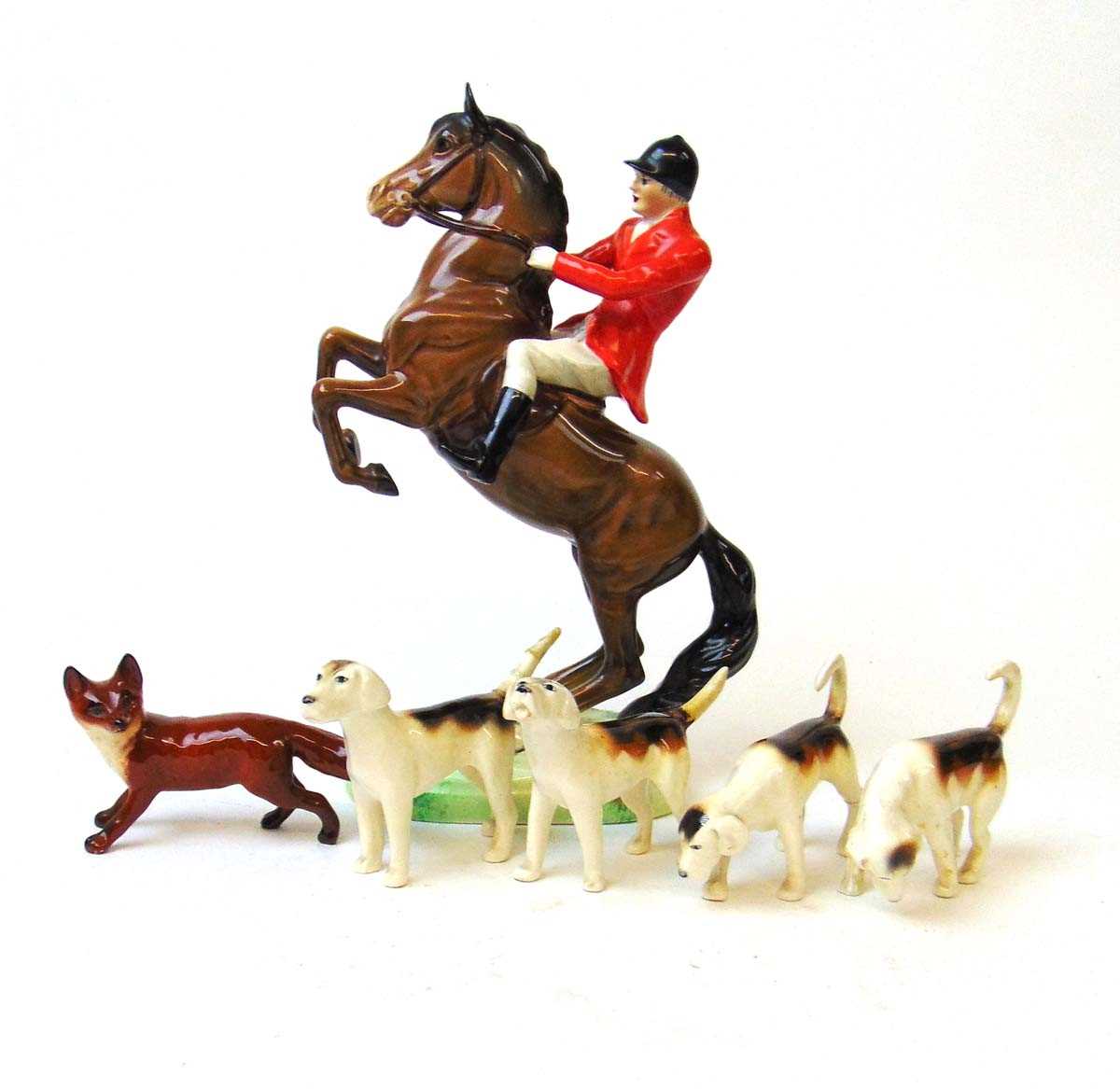 A Beswick figure of a huntsman on rearing horse, model 868, 24cm high, together with four hounds and - Image 2 of 2