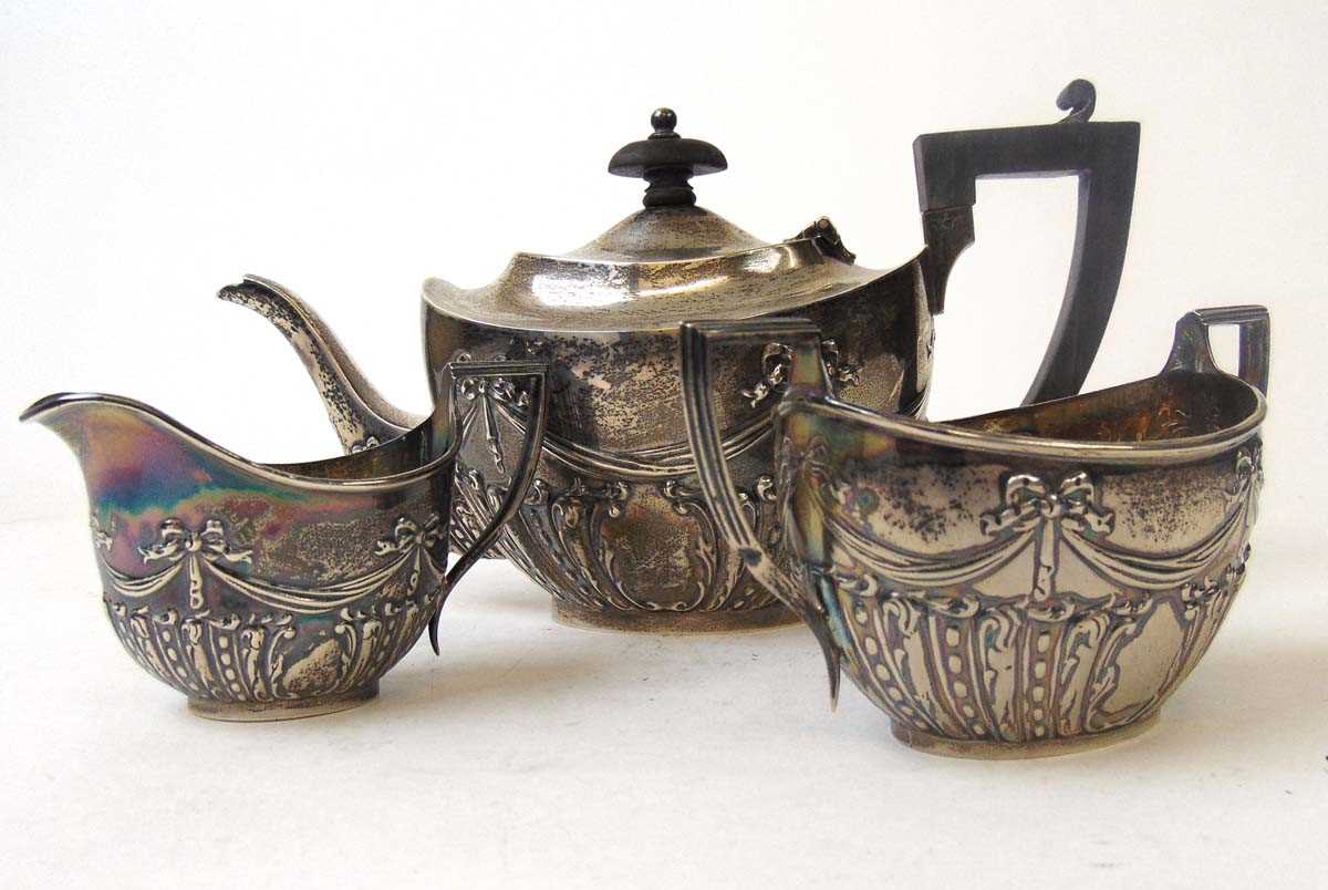 A bachelors silver tea set, Henry Matthews, Birmingham 1907, embossed with ribbons, beads and